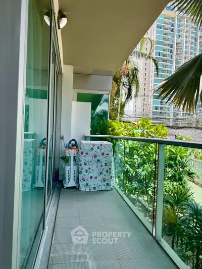 Spacious balcony with lush greenery and city view