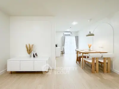 Spacious modern living and dining area with minimalist decor and natural light.