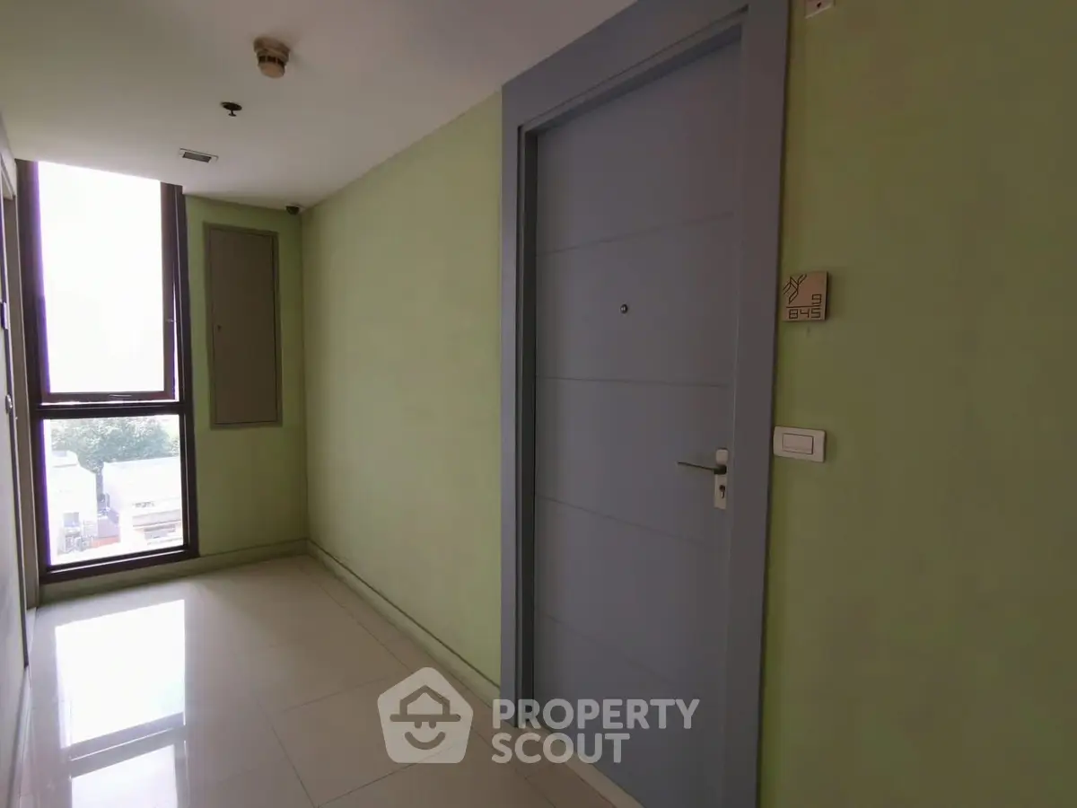 Modern apartment entrance with sleek door and bright hallway