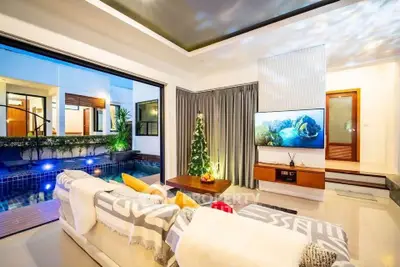 Luxurious living room with pool view, modern decor, and elegant lighting