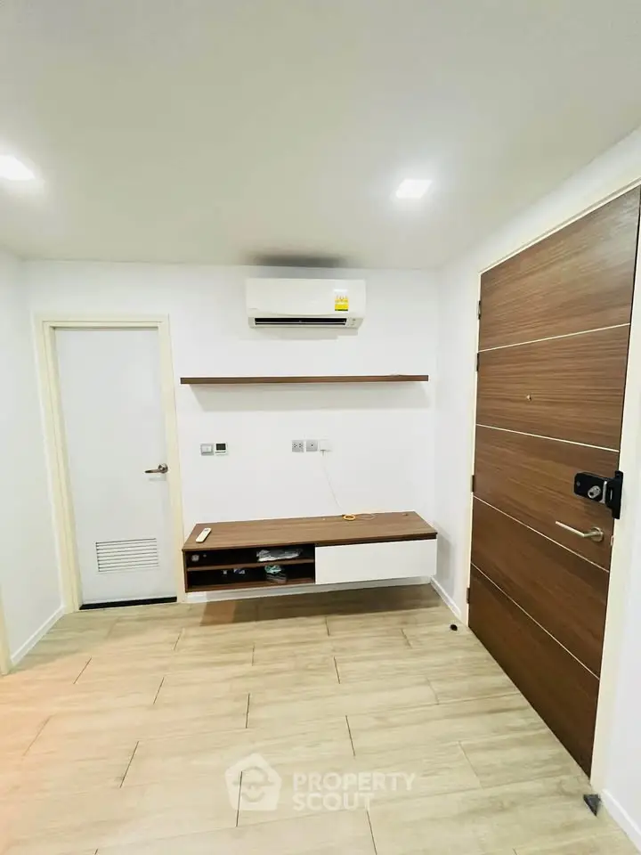 Modern minimalist interior with wooden flooring and air conditioning unit