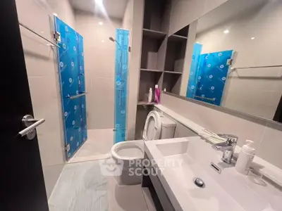 Modern bathroom with sleek fixtures and spacious shower area