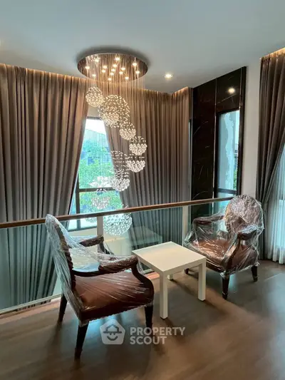 Luxurious living area with elegant chairs and modern lighting