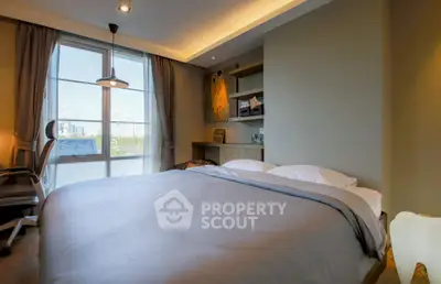 Spacious bedroom with large window and modern decor in a luxury apartment.