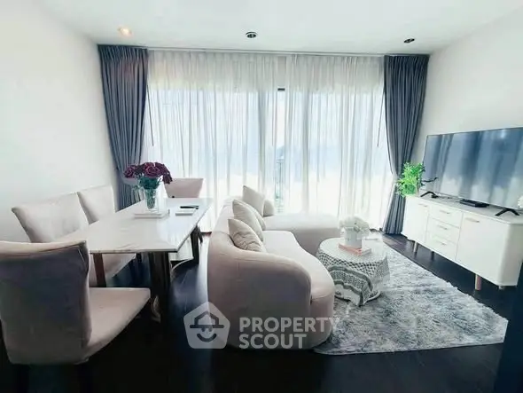 Elegant living room with modern furniture and large windows for natural light.