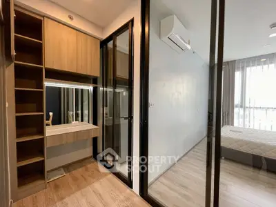Modern bedroom with glass partition and wooden flooring