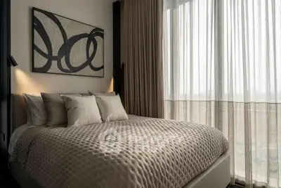 Luxurious bedroom with elegant decor and large window for natural light