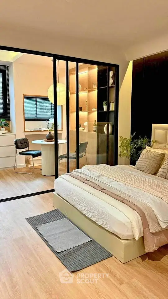 Modern bedroom with sliding glass doors leading to a stylish dining area.