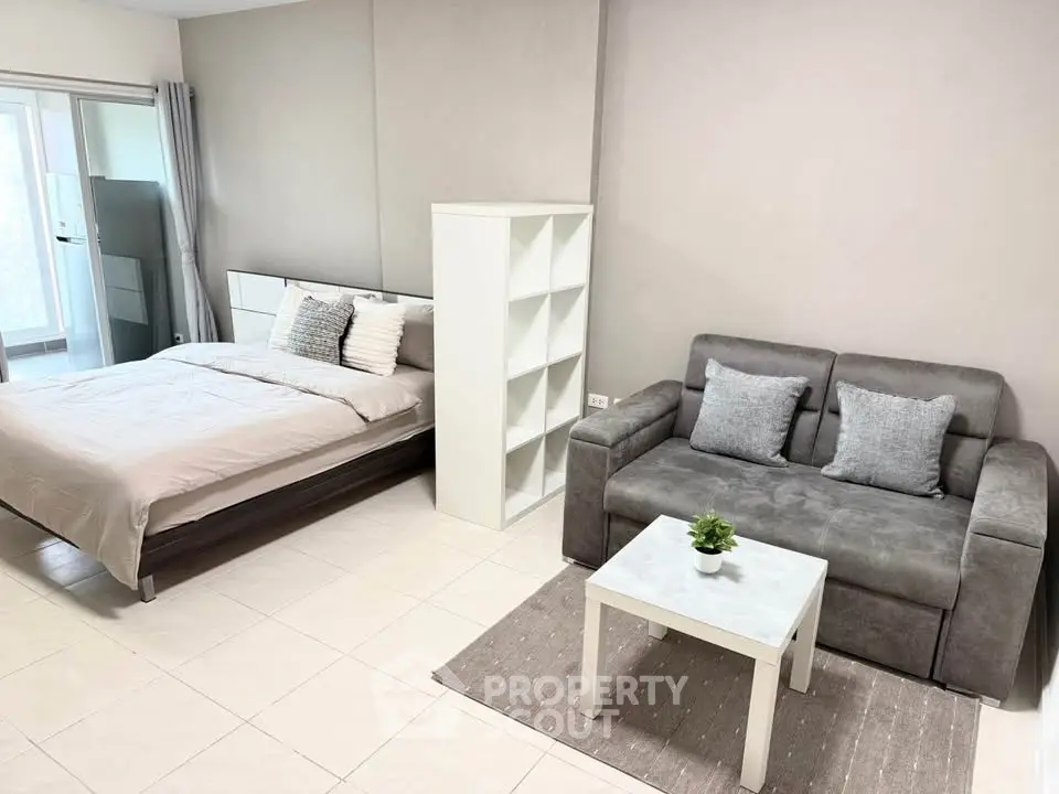 Modern studio apartment with cozy bed and stylish sofa in open layout