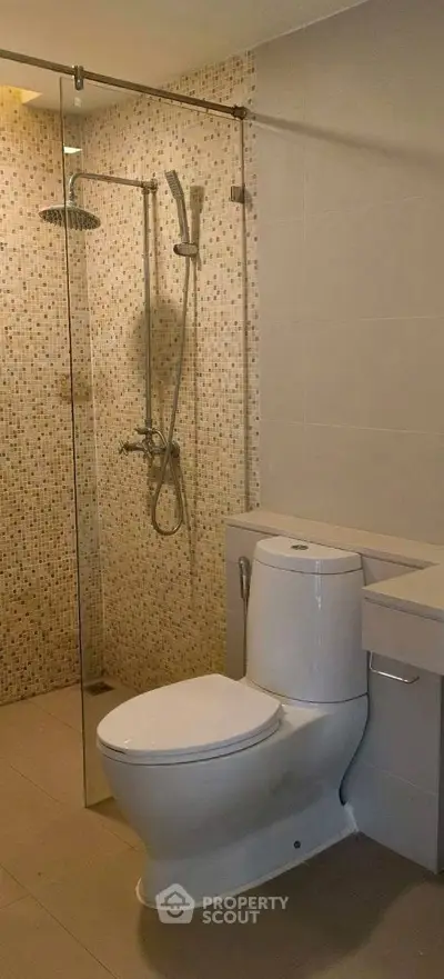 Modern bathroom with glass shower and sleek toilet design