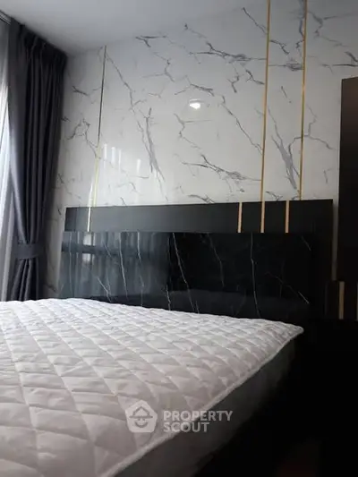 Luxurious bedroom with marble accent wall and elegant bedding