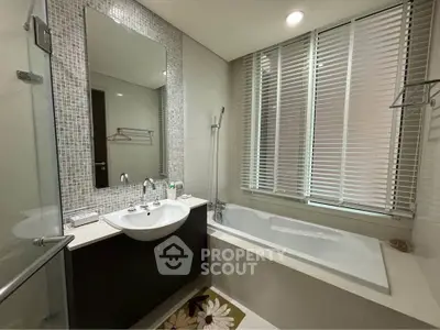 Modern bathroom with sleek design, featuring a bathtub and stylish fixtures, perfect for relaxation.