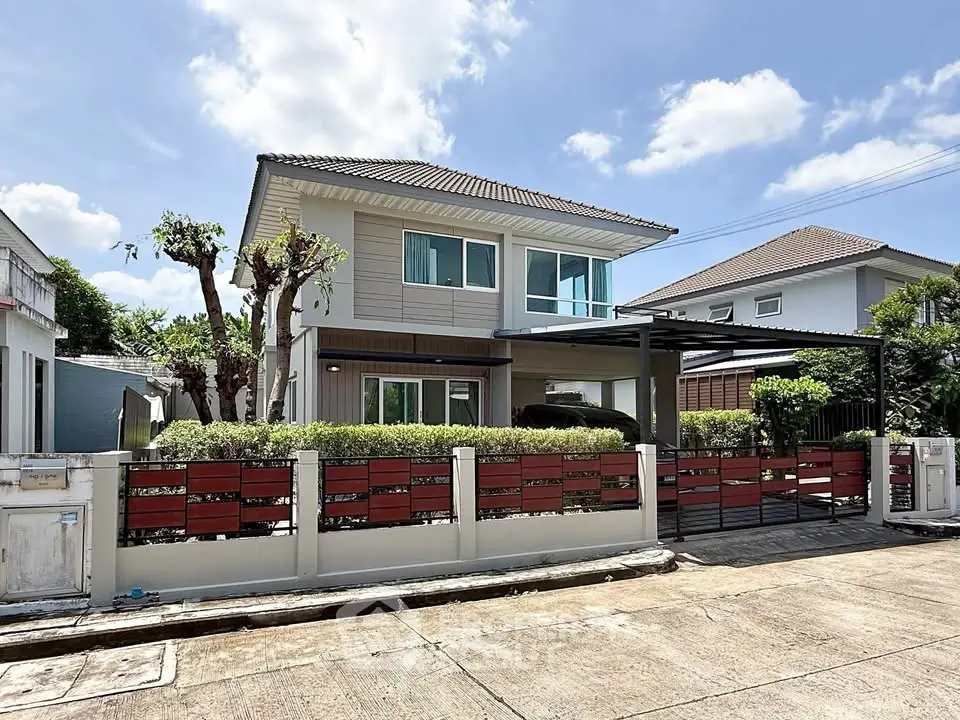 Charming two-story house with modern design, lush greenery, and spacious driveway in a serene neighborhood.