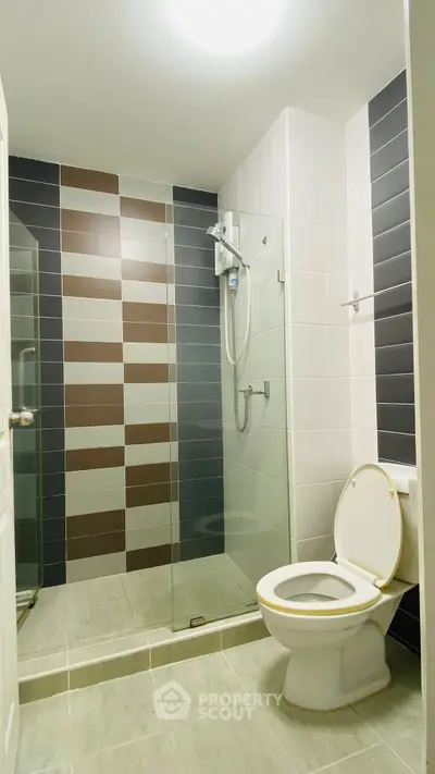 Modern bathroom with glass shower and stylish tile design