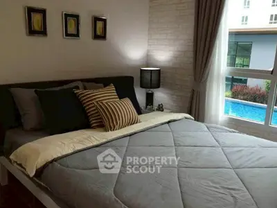 Cozy bedroom with pool view, modern decor, and ample natural light.