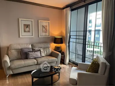 Cozy living room with elegant decor and balcony view in modern apartment.