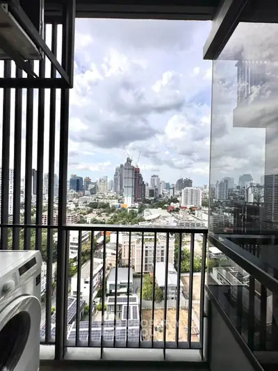 Stunning city view from a modern balcony with washing machine, perfect for urban living.