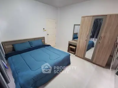 Cozy bedroom with modern furniture and blue bedding