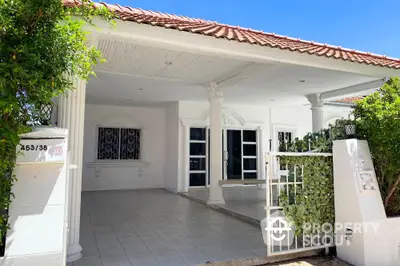 Charming white exterior house with tiled roof and elegant columns