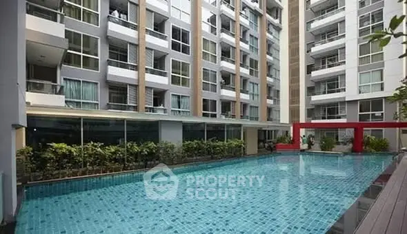 Modern apartment building with a luxurious outdoor pool and stylish design.