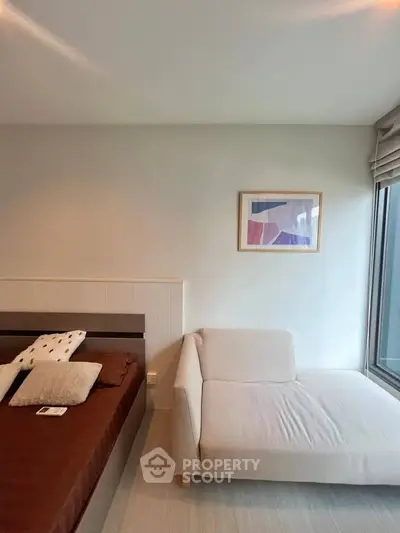 Modern bedroom with stylish decor and large window for natural light