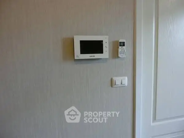 Modern home interior with smart thermostat on wall
