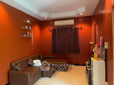 Cozy living room with modern brown sofa and air conditioning