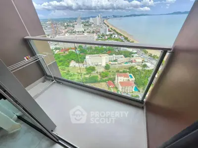 Stunning high-rise balcony with panoramic ocean and city views, perfect for relaxation and enjoying sunsets.