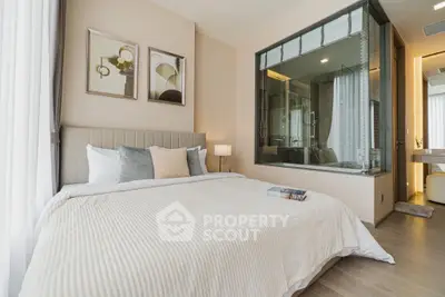 Modern bedroom with glass-enclosed bathroom and elegant decor