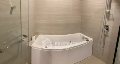 Luxurious bathroom with modern bathtub and sleek shower design