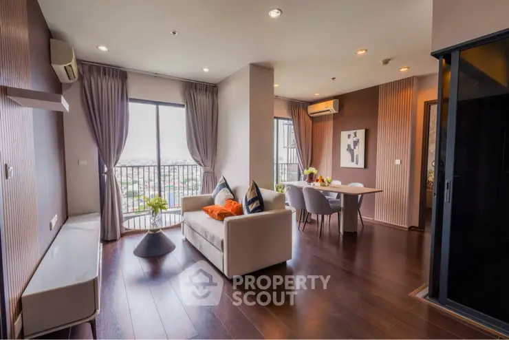 Modern living room with city view, featuring elegant decor and ample natural light.