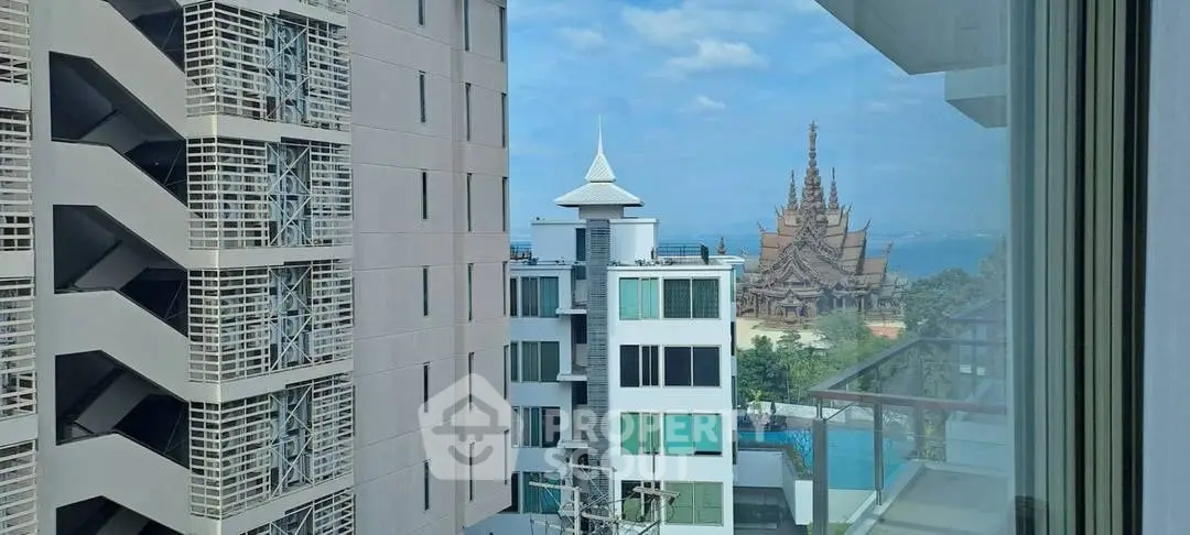 Stunning cityscape view from a modern building with ocean and architectural landmark.