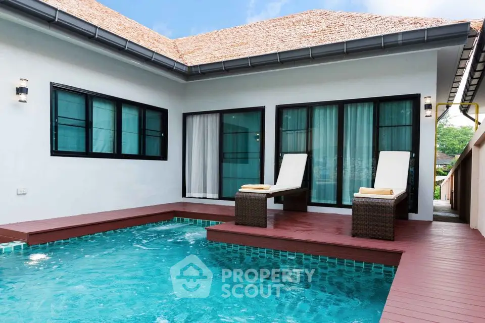 Luxurious villa with private pool and sun loungers, perfect for relaxation and leisure.
