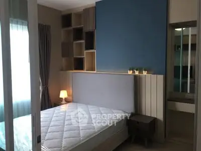 Modern bedroom with stylish shelving and cozy lighting in a contemporary apartment.