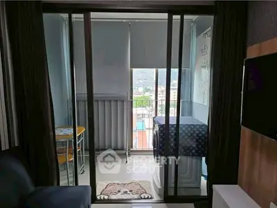 Cozy balcony with sliding glass doors and city view, perfect for relaxation.