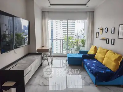 Modern living room with city view, featuring sleek furniture and large TV, ideal for urban living.