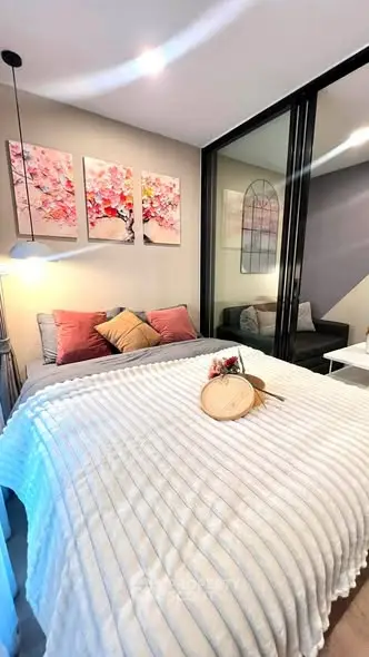 Cozy bedroom with modern decor and large glass sliding doors, perfect for relaxation.