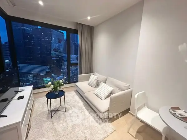 Modern living room with city view, cozy sofa, and elegant decor