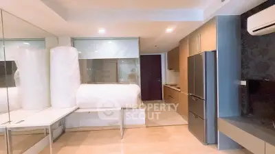 Modern apartment interior with kitchen and living area, featuring sleek appliances and stylish design.