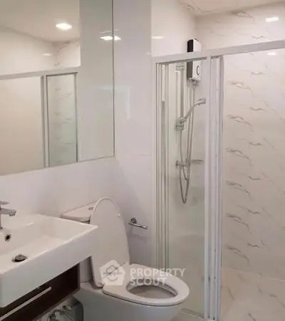 Modern bathroom with shower and sleek white fixtures