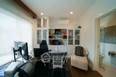 Modern home office with sleek desk, ergonomic chair, and built-in storage in a bright, airy room.