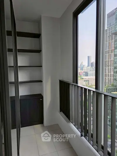 Modern high-rise apartment balcony with city skyline view and sleek shelving.