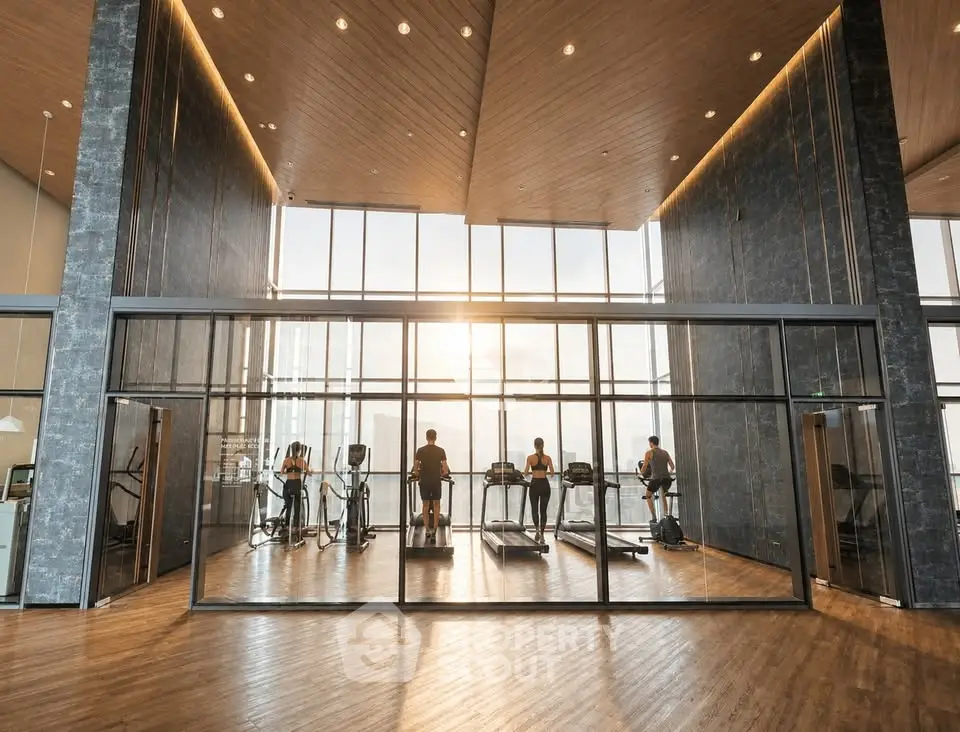 Luxurious gym with floor-to-ceiling windows offering stunning views and modern fitness equipment.