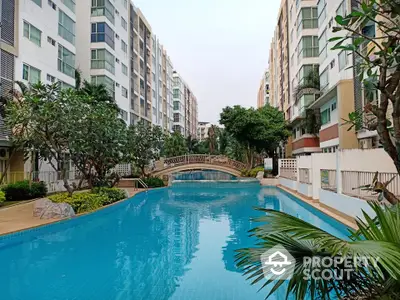 Luxurious residential complex with stunning pool and lush greenery