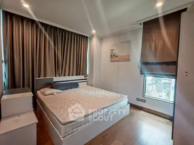 Modern bedroom with large window and cozy decor in urban apartment