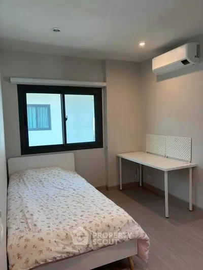 Cozy bedroom with modern air conditioning and natural light, perfect for restful nights.