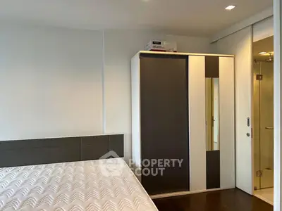 Modern bedroom with sleek wardrobe and comfortable mattress in a stylish apartment.