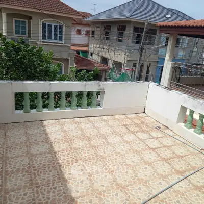 Spacious tiled balcony with surrounding residential views, perfect for outdoor relaxation.