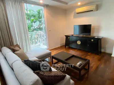 Stylish living room with modern furniture and balcony view, perfect for relaxation and entertainment.