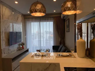 Modern living room with elegant lighting and marble accents, featuring a cozy seating area and large window view.